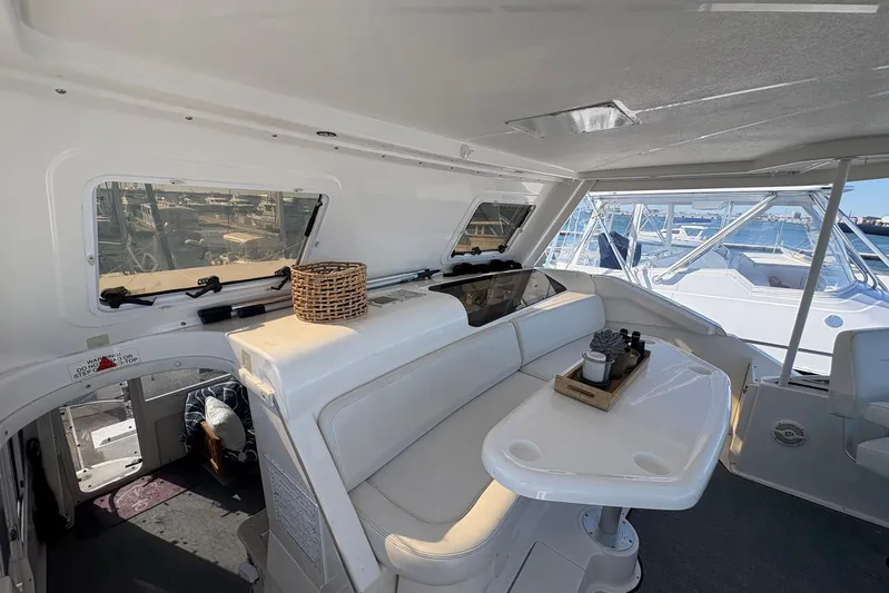 Lola's Ark III Yacht Photos Pics Interior of 2001 Silverton 453 Motor Yacht with white seating and table.