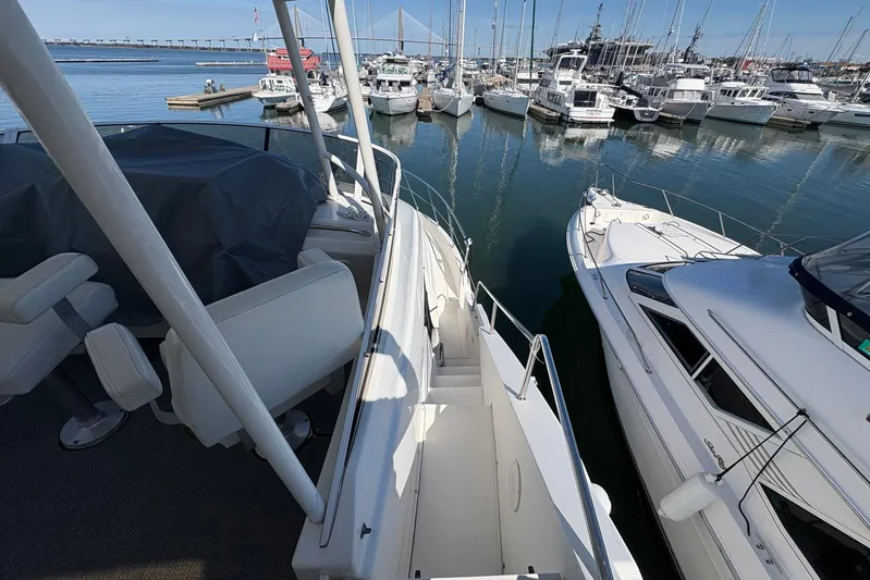 Lola's Ark III Yacht Photos Pics 2001 Silverton 453 Motor Yacht docked in a marina, surrounded by other boats.