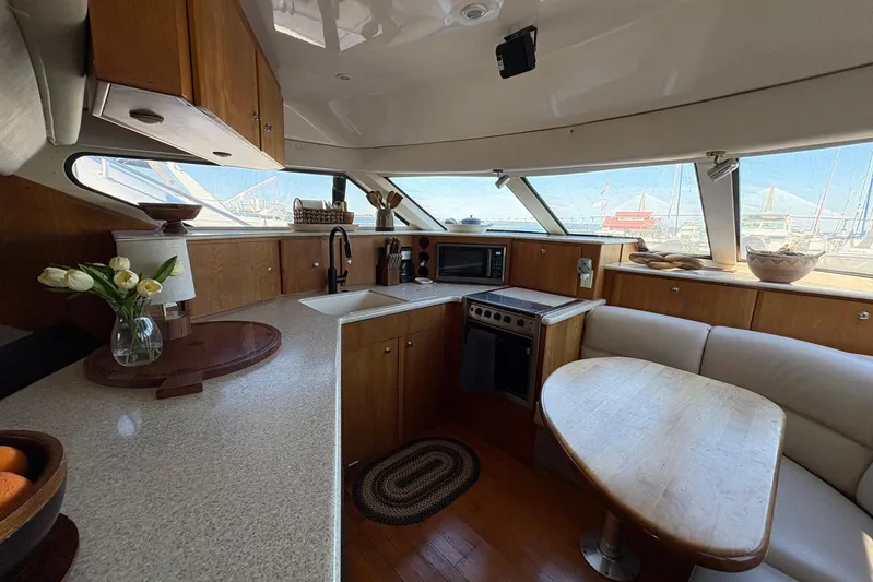 Lola's Ark III Yacht Photos Pics Luxurious 2001 Silverton 453 Motor Yacht interior with modern kitchen and dining area.