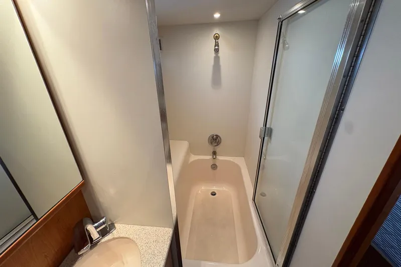Lola's Ark III Yacht Photos Pics Bathroom interior of 2001 Silverton 453 Motor Yacht with shower and sink.