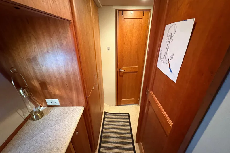Lola's Ark III Yacht Photos Pics Interior hallway of 2001 Silverton 453 Motor Yacht with wood paneling and anchor drawing.