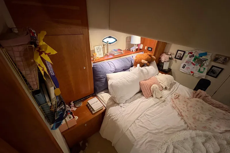 Lola's Ark III Yacht Photos Pics Cozy bedroom interior of 2001 Silverton 453 Motor Yacht with plush bedding and decor.