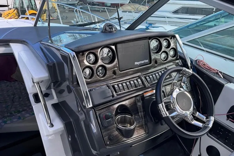  Yacht Photos Pics 2021 Monterey 295 Sport Yacht dashboard with steering wheel and navigation controls.