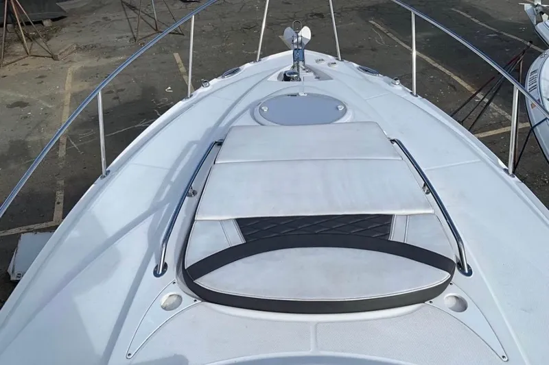  Yacht Photos Pics 2021 Monterey 295 Sport Yacht bow with sunpad and stainless steel rails.