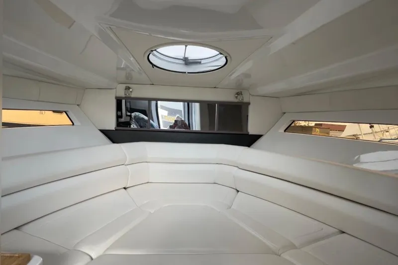  Yacht Photos Pics Interior of 2021 Monterey 295 Sport Yacht with white seating and circular skylight.