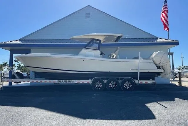  Yacht Photos Pics 2018 Chris-Craft Catalina 30 boat on trailer, parked outdoors under clear sky.