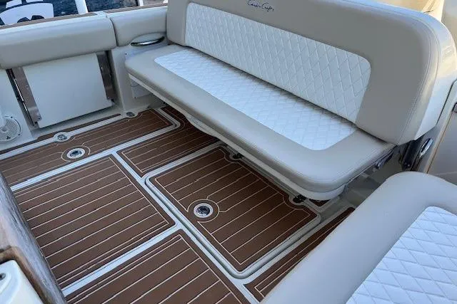  Yacht Photos Pics 2018 Chris-Craft Catalina 30 interior with cushioned seating and wood-patterned flooring.