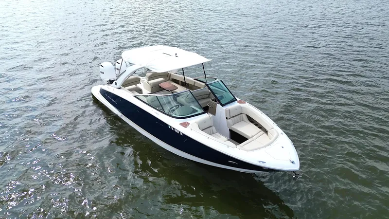  Yacht Photos Pics 2019 Regal 29 OBX boat on calm water, featuring sleek design and spacious seating.