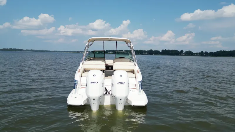  Yacht Photos Pics 2019 Regal 29 OBX boat with twin engines on a calm lake.