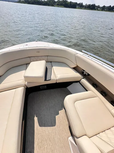  Yacht Photos Pics 2019 Regal 29 OBX boat with beige seating on a calm lake.