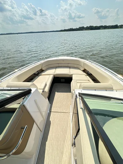  Yacht Photos Pics 2019 Regal 29 OBX boat interior with spacious seating on a calm lake.