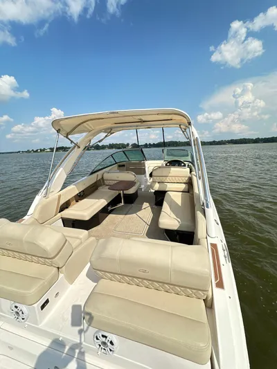  Yacht Photos Pics 2019 Regal 29 OBX boat with beige seating on a sunny lake.