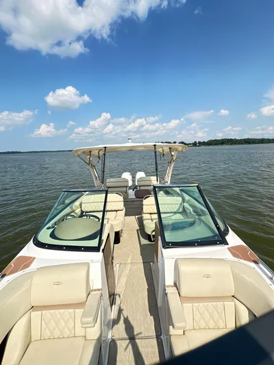  Yacht Photos Pics 2019 Regal 29 OBX boat on a lake under a clear blue sky.