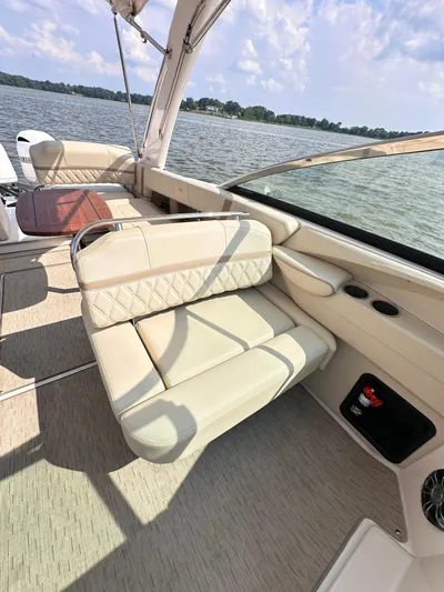  Yacht Photos Pics 2019 Regal 29 OBX boat interior with beige seating, lake view, and sunny weather.