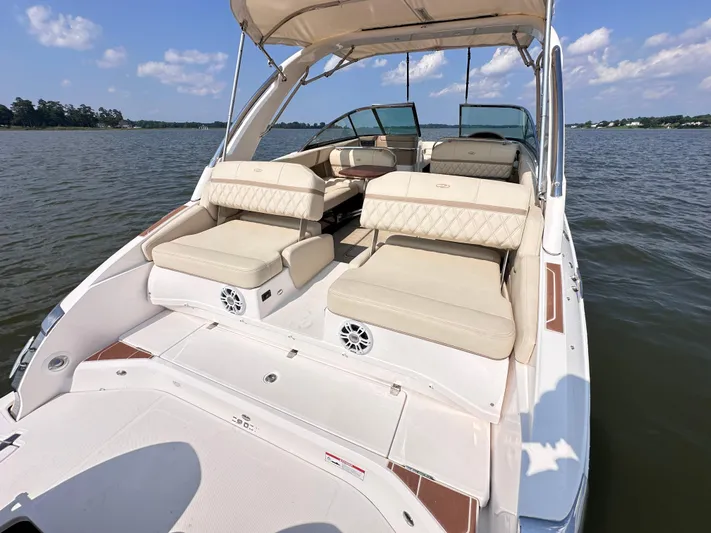  Yacht Photos Pics 2019 Regal 29 OBX boat with spacious seating on a calm lake.