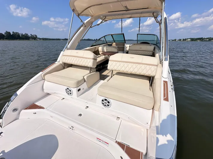  Yacht Photos Pics 2019 Regal 29 OBX boat with spacious seating on a calm lake.