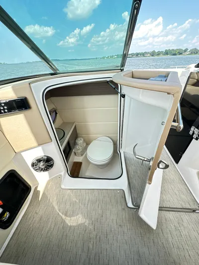  Yacht Photos Pics 2019 Regal 29 OBX boat interior with compact bathroom and lake view.