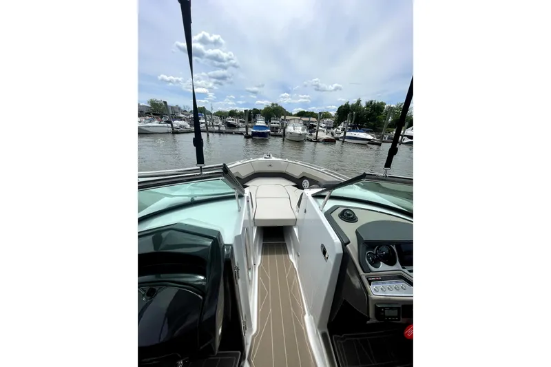  Yacht Photos Pics 2023 Monterey 275SS Super Sport boat interior with marina view, featuring sleek design and modern controls.