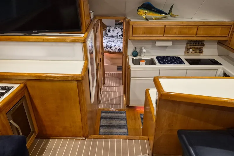 Reel Dreams Yacht Photos Pics Interior of 1995 Bertram 43 Convertible yacht with kitchen and cozy cabin.