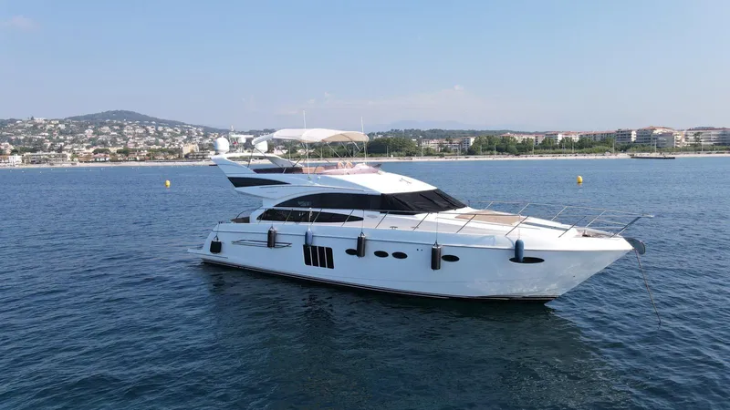  Yacht Photos Pics Luxury yacht Princess 64 FLY 2012 on calm sea near coastal cityscape.