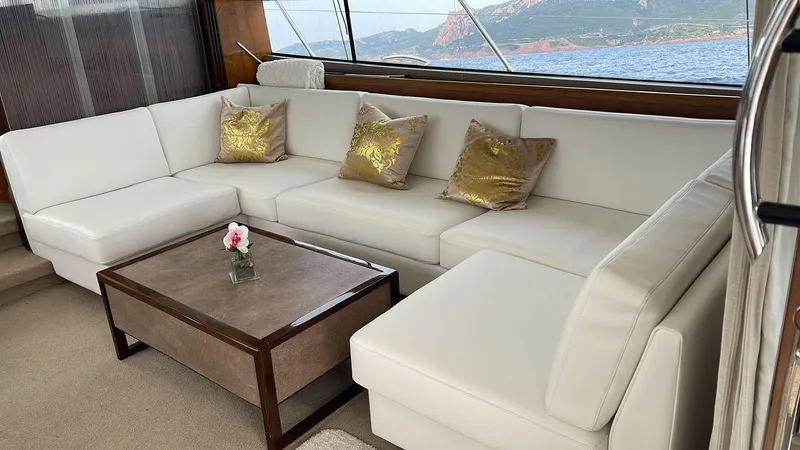  Yacht Photos Pics Luxurious interior of 2012 Princess 64 FLY yacht with white sofa and gold pillows.