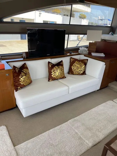  Yacht Photos Pics Luxurious interior of 2012 Princess 64 FLY yacht with elegant white sofa and decorative pillows.