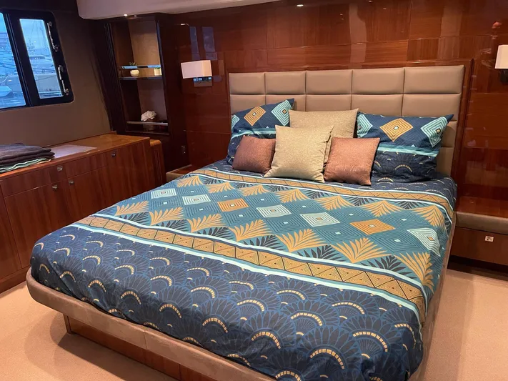  Yacht Photos Pics Luxurious bedroom interior of 2012 Princess 64 FLY yacht with elegant bedding and wood paneling.