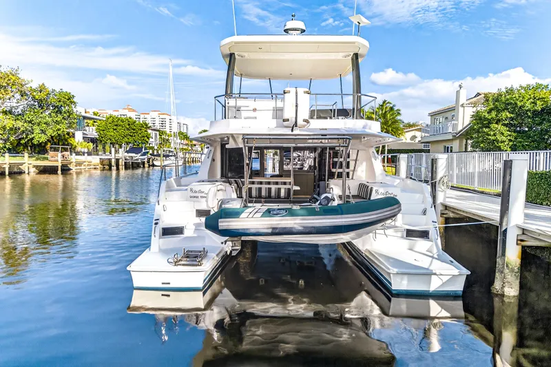  Yacht Photos Pics 2017 Leopard 43 Powercat yacht docked in a serene marina setting.