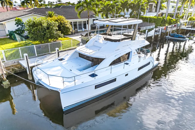  Yacht Photos Pics 2017 Leopard 43 Powercat yacht docked in a serene waterfront setting.