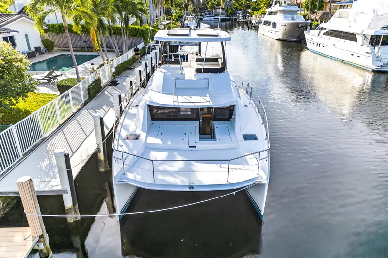  Yacht Photos Pics 2017 Leopard 43 Powercat docked in a serene canal setting.