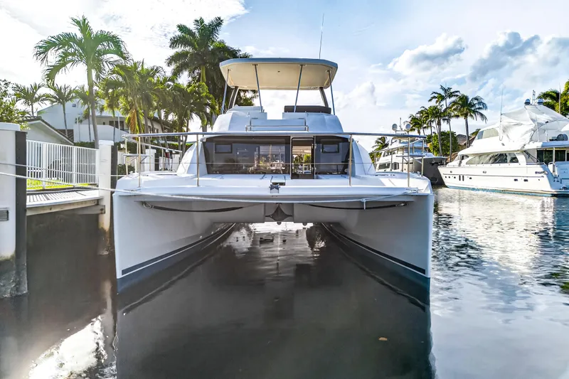  Yacht Photos Pics 2017 Leopard 43 Powercat yacht docked in a serene marina setting.