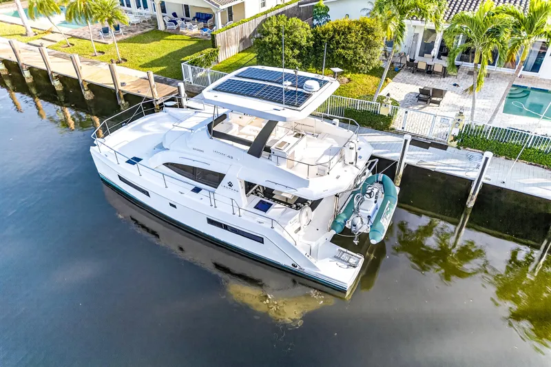  Yacht Photos Pics 2017 Leopard 43 Powercat yacht docked by waterfront home with solar panels.