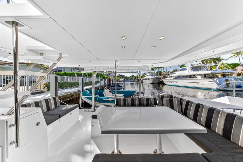  Yacht Photos Pics Spacious deck of 2017 Leopard 43 Powercat with striped seating and marina view.