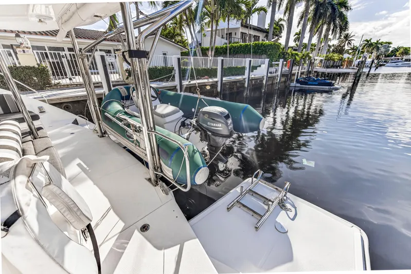  Yacht Photos Pics 2017 Leopard 43 Powercat with dinghy and Yamaha motor docked by waterfront homes.