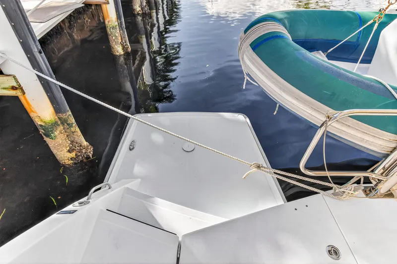  Yacht Photos Pics 2017 Leopard 43 Powercat docked with inflatable boat, showing stern and water reflections.