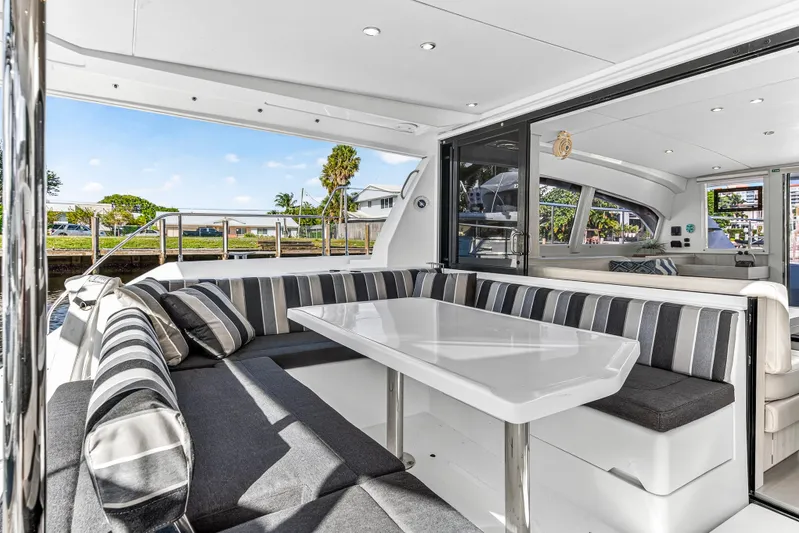  Yacht Photos Pics Luxurious interior of 2017 Leopard 43 Powercat with striped seating and sleek table.