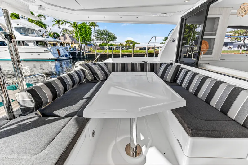  Yacht Photos Pics Luxurious seating area on a 2017 Leopard 43 Powercat yacht, featuring striped cushions.