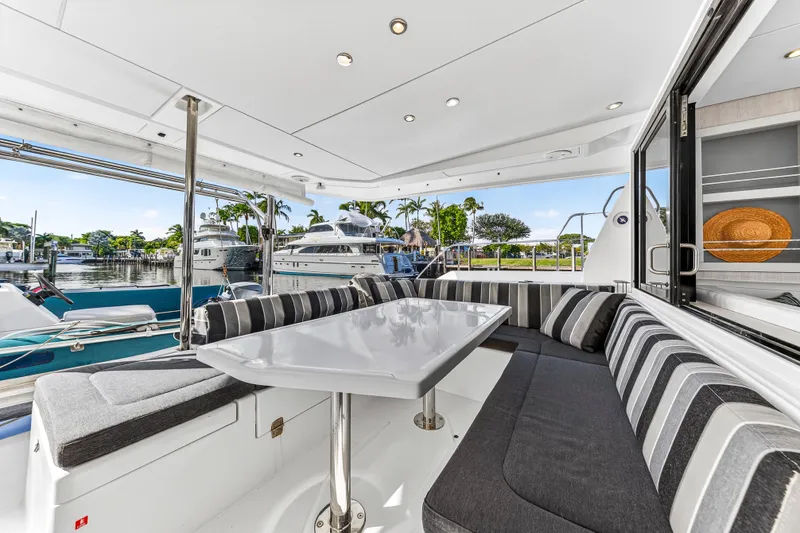  Yacht Photos Pics 2017 Leopard 43 Powercat yacht interior with striped seating and marina view.