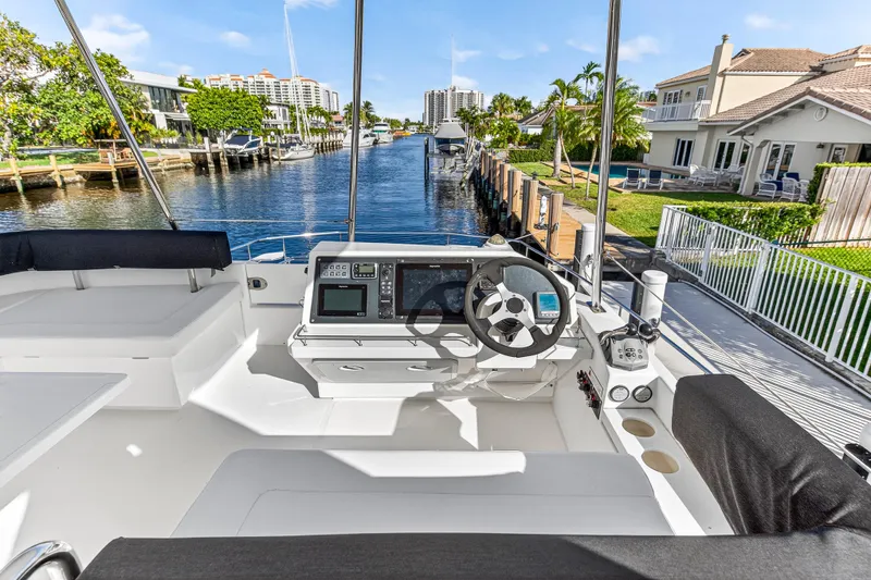  Yacht Photos Pics Flybridge view of 2017 Leopard 43 Powercat, overlooking a serene waterfront neighborhood.