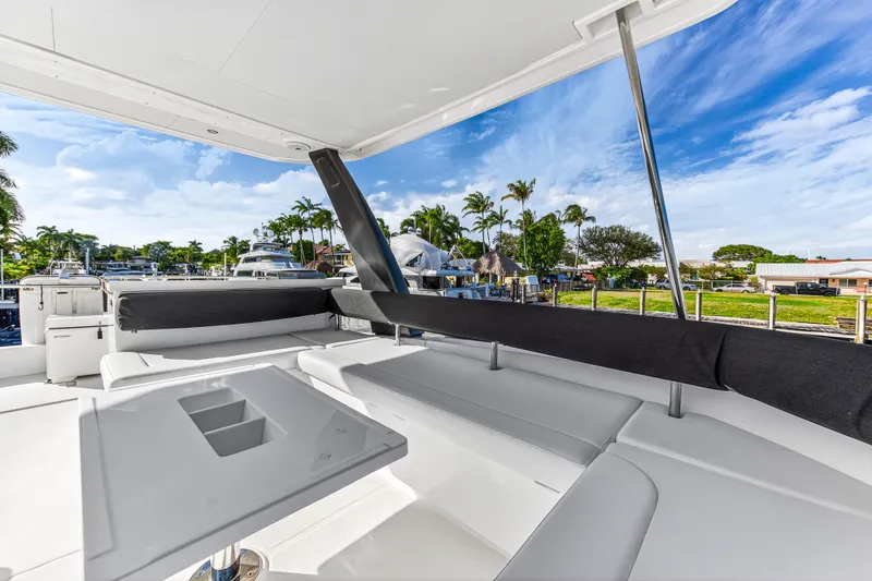  Yacht Photos Pics 2017 Leopard 43 Powercat yacht deck with seating, table, and scenic marina view.
