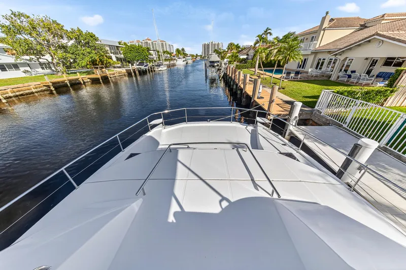  Yacht Photos Pics 2017 Leopard 43 Powercat docked in a scenic residential canal.