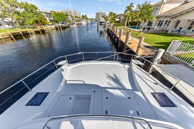  Yacht Photos Pics 2017 Leopard 43 Powercat yacht docked in a scenic canal with waterfront homes.