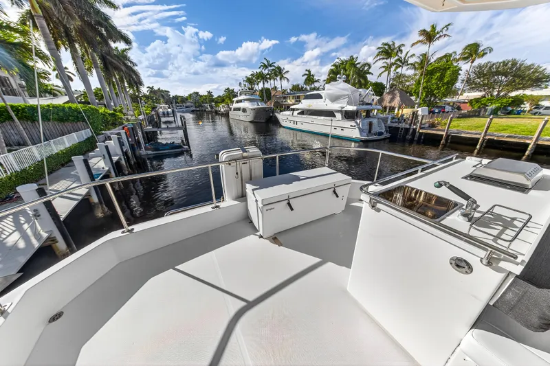  Yacht Photos Pics 2017 Leopard 43 Powercat yacht docked in a scenic canal with palm trees.