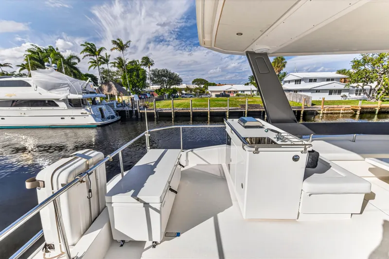 Yacht Photos Pics 2017 Leopard 43 Powercat yacht deck with outdoor seating and waterfront view.