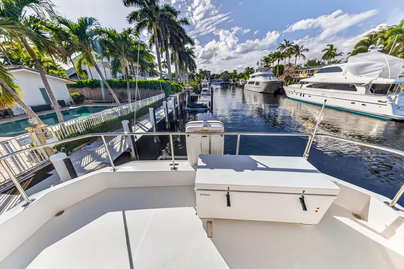  Yacht Photos Pics 2017 Leopard 43 Powercat docked in a sunny marina with palm trees and yachts.