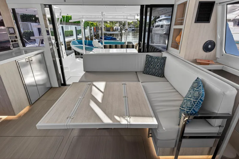  Yacht Photos Pics 2017 Leopard 43 Powercat interior with modern seating, table, and waterfront view.