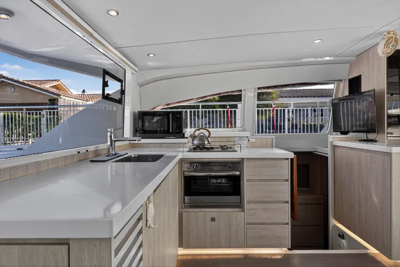  Yacht Photos Pics Modern kitchen interior of 2017 Leopard 43 Powercat yacht with sleek countertops and appliances.