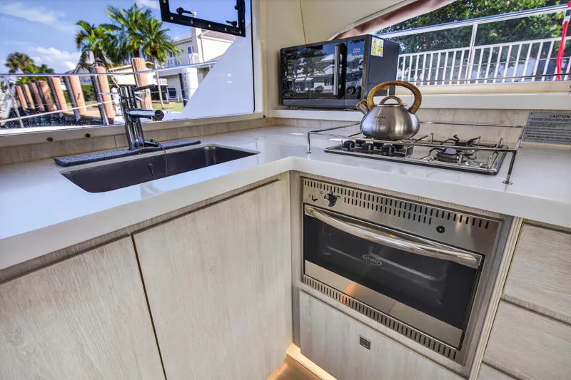  Yacht Photos Pics Modern kitchen in a 2017 Leopard 43 Powercat yacht with stove, oven, and sink.