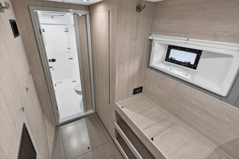  Yacht Photos Pics 2017 Leopard 43 Powercat interior with modern bathroom and wooden cabinetry.