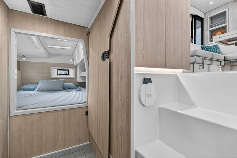  Yacht Photos Pics Interior of 2017 Leopard 43 Powercat, featuring cozy bedroom and modern staircase design.